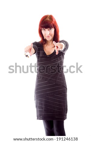 Mature woman pointing towards camera from both hands