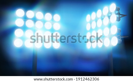 Bright floodlights at a sports stadium. Show stage on a blue background. Sports game. Abstract vector illustration. Royalty-Free Stock Photo #1912462306