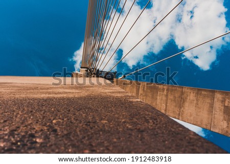 view from below on the part of the bridge with blue sky in background