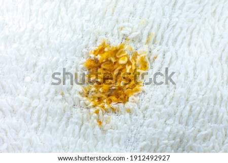 Dirty food stain on white cotton towel or carpet. Close up photo.