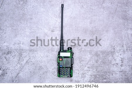 walkie-talkies on gray concrete background, top view space for text