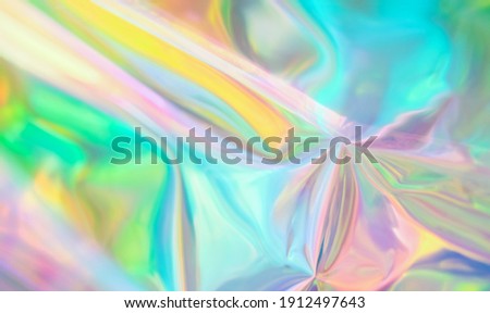 Holographic iridescent surface wrinkled vaporwave wavy abstract  blurred background. Texture with multiple colors of webpunk in 80's style. Retro creative concept.  Royalty-Free Stock Photo #1912497643