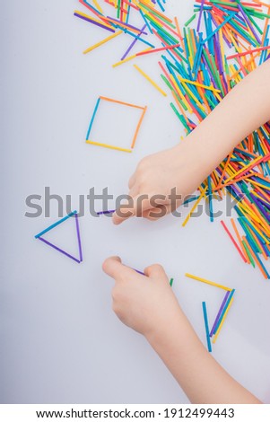 Kid making triangle and rectangular shape as creative concept