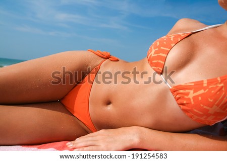 Picture with beach and tanned female body