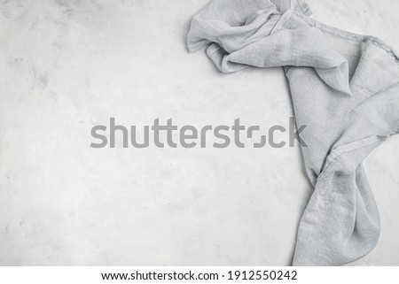 Grey  background with grey  textile napkin. Food background for recipe, cooking ingredients and restaurant design with copy space for text Royalty-Free Stock Photo #1912550242