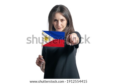 Happy young white woman holding flag of Philippines and points forward in front of him isolated on a white background.