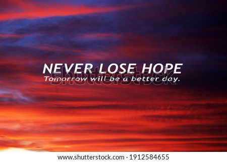 Hope inspirational quote - Never lose hope. Tomorrow will be a better day. Motivational words message in the sky on colorful dramatic clouds background in blue red and orange sunset sky cloud colors .