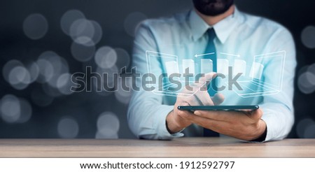 business man hand tablet with transfer file Royalty-Free Stock Photo #1912592797
