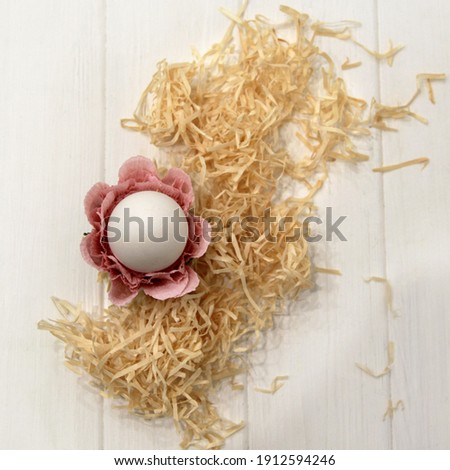 Holiday decor, Easter egg decoration in the form of a flower on a straw