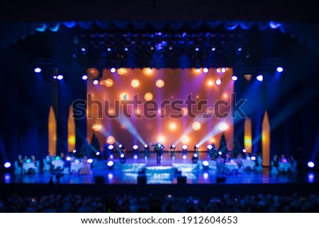 blur background, texture for design. Spotlights in the concert hall and screen on the background.