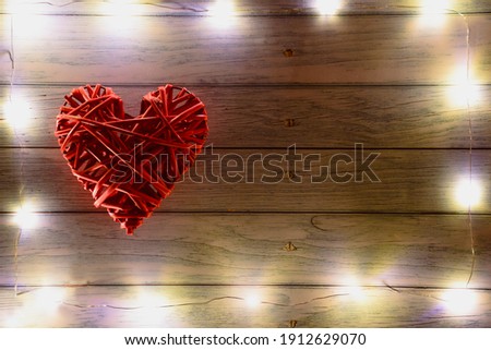 Large red braided decorative heart on the left side. There are glowing lights around the frame. On the right there is a place for an inscription for different holidays.