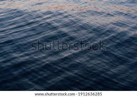 Blurred water surface, beautiful abstract background, reflected sky. Outdoors. Horizontal photography