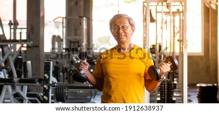Old man exercising in the gym Enhance health For strength Exercise concept