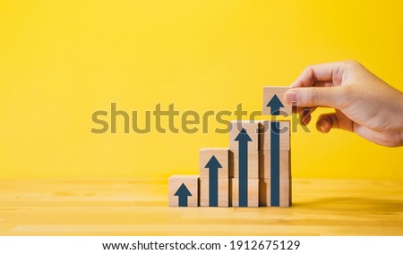 Business growth or step for success concepts with arrow graph, on wood.financial,profit of investment. Royalty-Free Stock Photo #1912675129