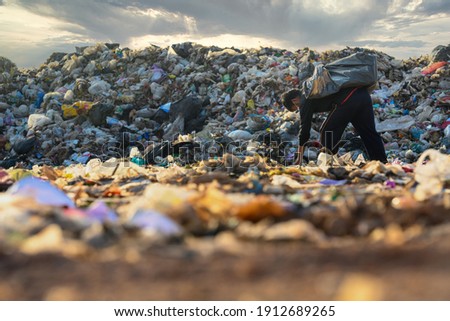 Poor people collect garbage for sale People living in garbage heaps walking to collect recyclable waste to be sold to poverty concept world environment day Royalty-Free Stock Photo #1912689265