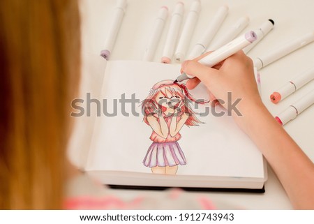 Hand drawing a cute girl anime style sketch with alcohol based sketch drawing markers. Royalty-Free Stock Photo #1912743943