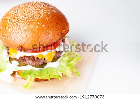 Isolated tasty burger with cheese and tomato