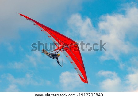 Bright paraglider wing in the sky. Extreme sports Royalty-Free Stock Photo #1912795840