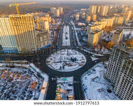 Aerial photo of Kyiv city districts in winter. Real estate houses and road circle