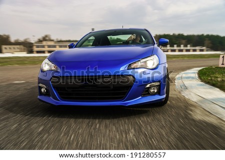 Blue sport car on race way. Motion capture. Royalty-Free Stock Photo #191280557