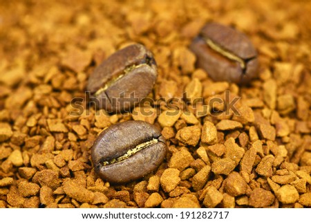 golden ground coffee background with coffee beans