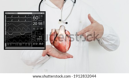 Heart anatomy, Cardiologist on blurred background, patient monitor graphic, ecg, combination of 3d and photo Royalty-Free Stock Photo #1912832044