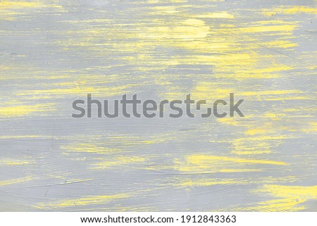 Abstract yellow and gray acrylic pattern. A trendy background made from a mix of yellow and gray colors.