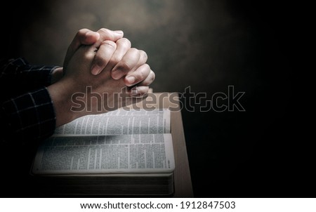 Christian life crisis prayer to god. Man Pray for god blessing to wishing have a better life. man hands praying to god with the bible. believe in goodness. Holding hands in prayer on a wooden table. Royalty-Free Stock Photo #1912847503
