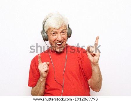 Photo of crazy optimistic old man listen music dance arms wear headphones isolated on white background. Dance with me.