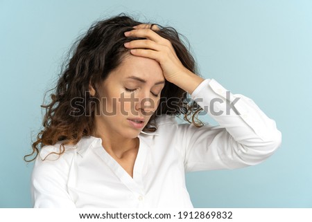 Studio portrait of tired frustrated business woman or office worker touching her forehead, has emotional burnout, exhausted by long work during hot weather in the office, isolated. Mental health. Royalty-Free Stock Photo #1912869832
