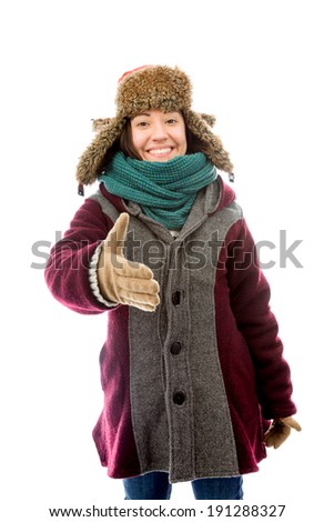 Young woman in warm clothing and offering hand for handshake