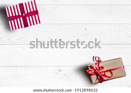Valentine day composition: white gift boxes with bow and red felt hearts, photo template, background. Top View. View from above