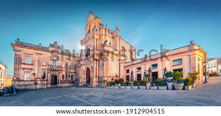 Empty Piazza Duomo square with  Duomo San Giorgio - baroque Catholic church. Bright morning cityscape of Ragusa, Sicily, Italy, Europe. Traveling concept background. Wide angle picture.