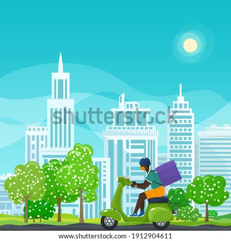 Young african guy in protective face mask with box for food delivery rides a green scooter on a spring background of green trees and cities, online delivery service and stay home concept