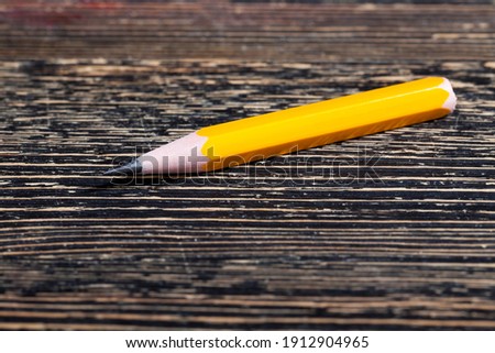 ordinary yellow wooden pencil with gray soft lead for drawing and creativity, close up of pencils after sharpening, pencil made of natural materials