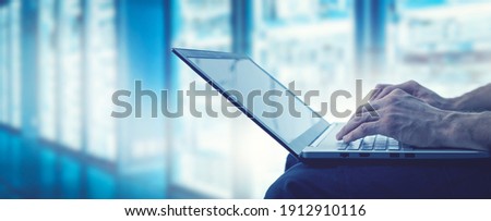 server support and management - it technician working on laptop in data center server room. copy space Royalty-Free Stock Photo #1912910116