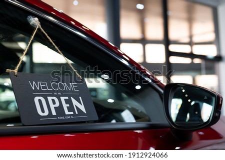 open car  with red car in dealership for door car  ideas unlock freedom tourist travel for lifestyle customer from salesman sign welcomenew normol during Coronavirus disease covid-19 unlock lockdown