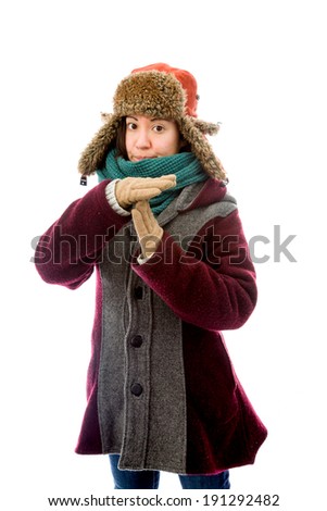 Young woman in warm clothing and making time out signal with hands