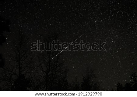 A comet crosses the nightsky in Inari, FInland
