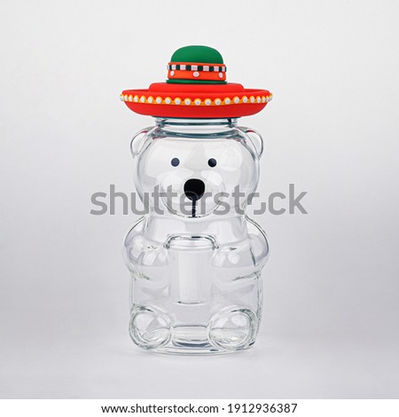 ฺGlass mugs Bear wearing a mexican hat on the White background.