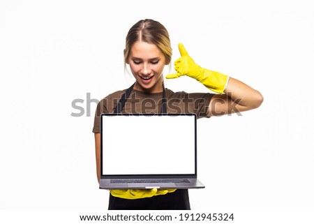 Young housewife with apron holding a computer with screen to research online on isolated a white background.