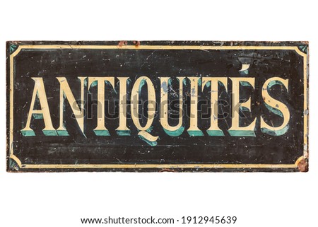 Old advertisement sign with the French text "Antiques" isolated on a white background