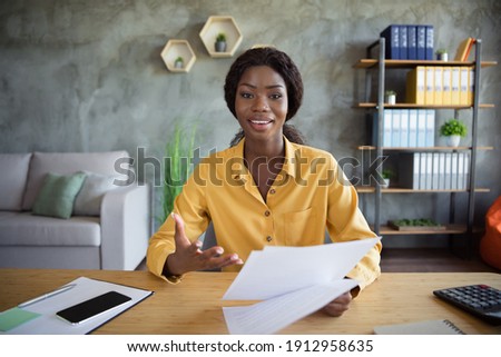 Photo of young dark skin woman hold resume talk webcam interview employer indoors in office workstation