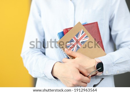 Female silhouette holding diaries with British flag. Self-study foreign languages concept