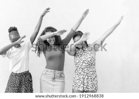 Three nice-looking good-dressed cute sweet gorgeous brunette hair lady stand isolated on white wall make dabbing movement. Black and white picture.