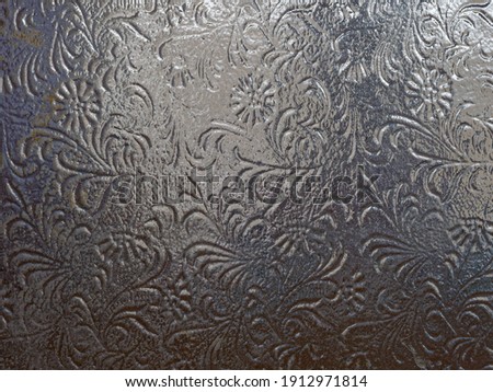 Dark glass texture with patterns, glass texture behind which there is light, background concept for the site