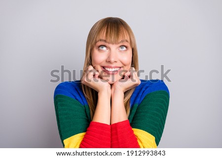 Photo portrait of dreamy funny blonde woman looking at up empty space touching hands cheekbones isolated on pastel grey color background