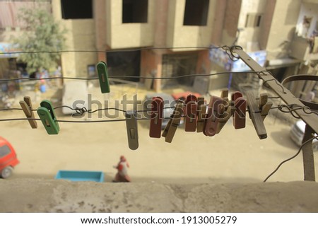 Rows of clothes pins to hold dry clothes. clothes pins and the line in the balcon apartemen. With green, red and brown color clothes pins. And brown color make it from wooden of plant.
