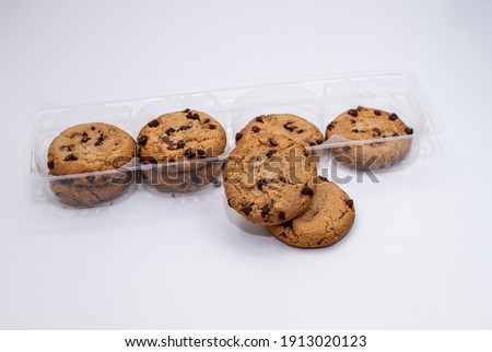 Oatmeal cookies in plastic packaging, baked goods on a white background. 