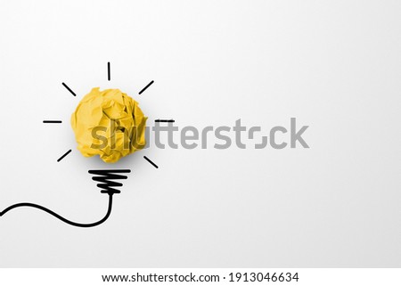 Creative thinking ideas and innovation concept. Paper scrap ball yellow colour with light bulb symbol on white background Royalty-Free Stock Photo #1913046634